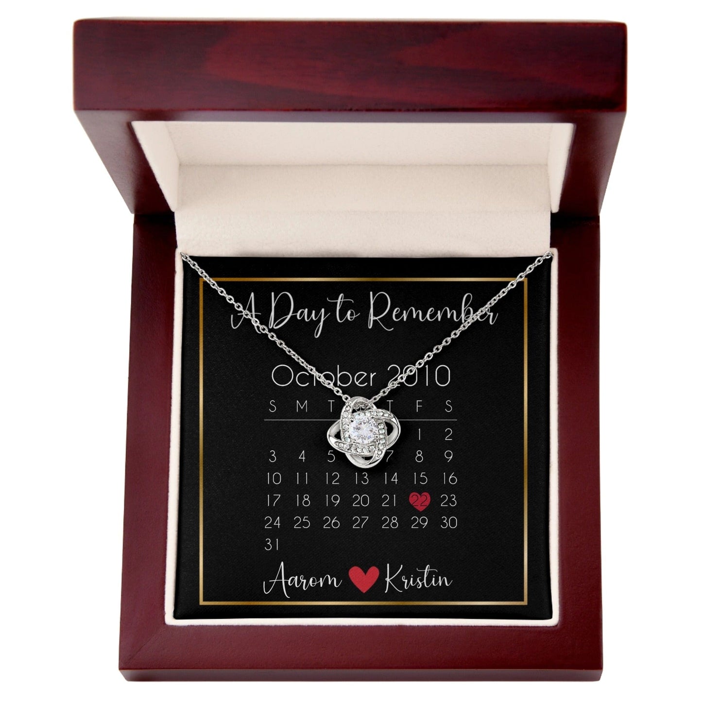 Personalized message card love knot necklace called "A Day to Remember" with a calendar and personalized names at the bottom.