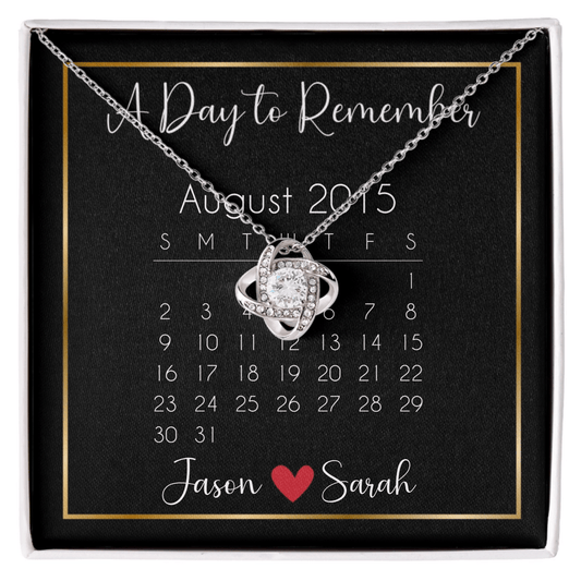 Personalized message card love knot necklace called "A Day to Remember" with a calendar and personalized names at the bottom.