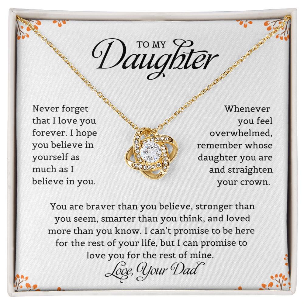 A necklace with a love knot pendant, accompanied by a card with a message to the daughter from dad expressing love and belief in her.
