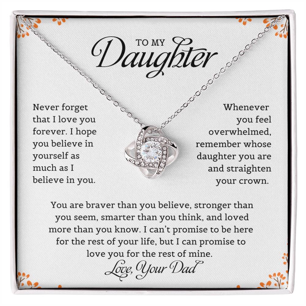 A necklace with a love knot pendant, accompanied by a card with a message to the daughter from dad expressing love and belief in her.