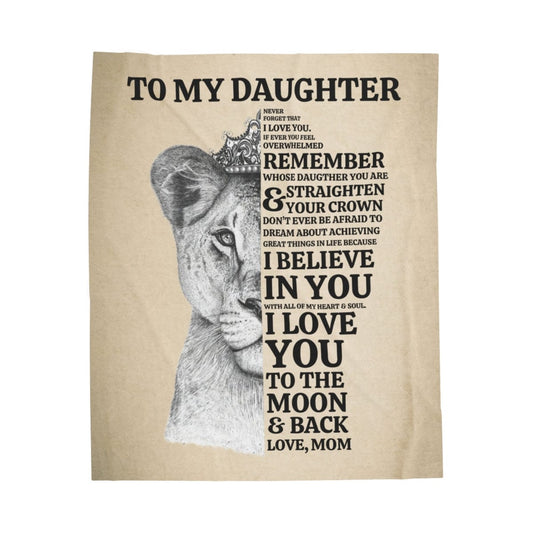 A tan blanket with a lioness face on it with a message from mom to daughter that says always remember whose daughter you are and straighten your crown. I believe in you and I love you to the moon and back.