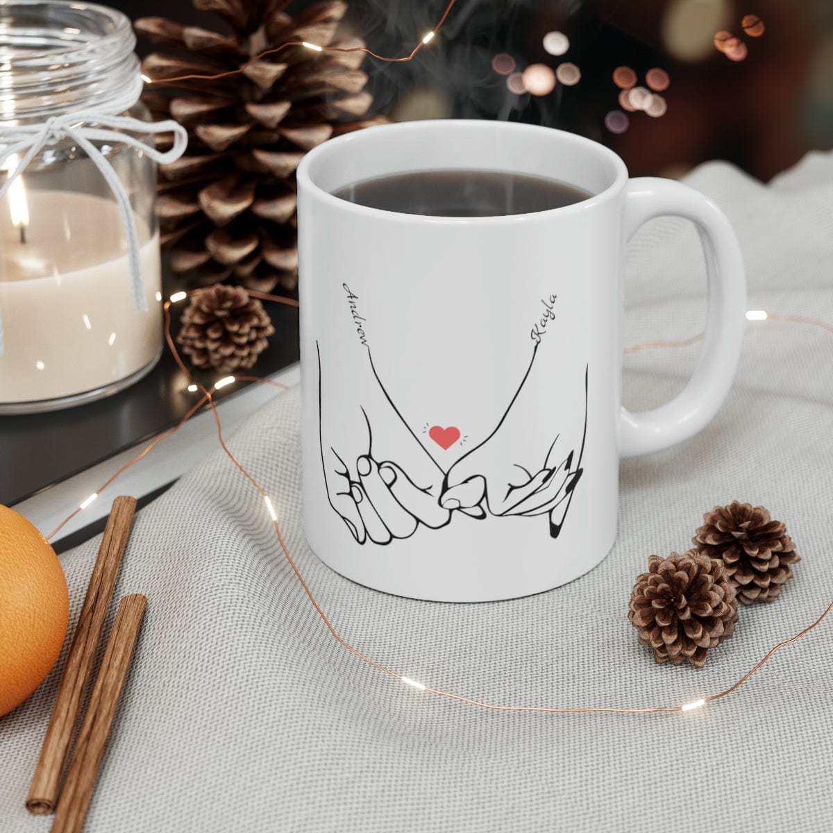 Line art drawing of hands holding pinkies with the couple's names added to personalize the coffee mug