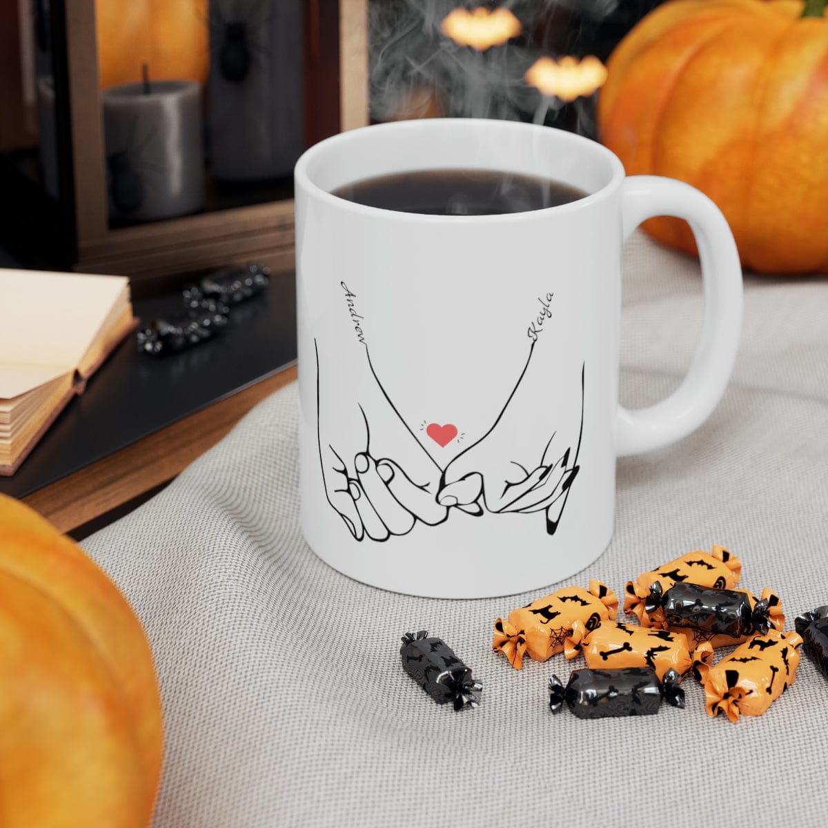 Line art drawing graphic  of hands holding pinkies with the couple's names added to personalize the coffee mug